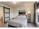 Bright bedroom with a queen bed, window, and barn door at 427 S Quay St, Lakewood, CO 80226