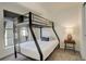 Bedroom with bunk bed, window, and nightstand at 427 S Quay St, Lakewood, CO 80226