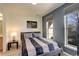 Cozy bedroom featuring a striped comforter and ample natural light at 427 S Quay St, Lakewood, CO 80226