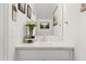 Bright bathroom with white vanity, single sink, and marble countertop at 500 S Denver Ave # 2B, Fort Lupton, CO 80621