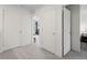 Bright hallway with carpet flooring and access to bedrooms at 500 S Denver Ave # 2B, Fort Lupton, CO 80621