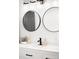 Bright bathroom featuring double sinks with round mirrors and modern fixtures at 2261 Blake St # 2G, Denver, CO 80205
