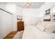 Bright bedroom featuring hardwood flooring, overhead lighting, neutral paint and a closet for storage at 2261 Blake St # 2G, Denver, CO 80205