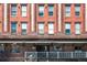 Close up of the building entrance of Palladium Lofts showcasing its brick facade at 2261 Blake St # 2G, Denver, CO 80205