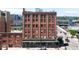 Brick apartment building with street view and mountain backdrop showcasing city living at 2261 Blake St # 2G, Denver, CO 80205