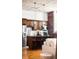 Cozy kitchen area with island, stainless steel fridge, and exposed brick detail at 2261 Blake St # 2G, Denver, CO 80205