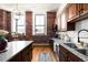 Kitchen with granite countertops, brick wall, modern appliances, and wood floors at 2261 Blake St # 2G, Denver, CO 80205