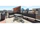 Rooftop deck area with outdoor seating, a grill, and views of the city at 2261 Blake St # 2G, Denver, CO 80205