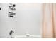 Tiled shower with chrome hardware and modern corner shelving for toiletries at 2261 Blake St # 2G, Denver, CO 80205