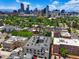 An aerial view showcasing the complex amidst a backdrop of the Denver skyline at 2120 N Downing St # 209, Denver, CO 80205