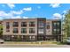 Modern building with a brick facade, balconies, and lots of windows at 2120 N Downing St # 209, Denver, CO 80205