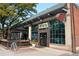 Bar Santos with a classic brick building, large windows, and a welcoming outdoor patio area at 2120 N Downing St # 209, Denver, CO 80205