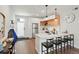 Modern kitchen with stainless steel appliances, white countertops, a breakfast bar, and stylish pendant lighting at 2120 N Downing St # 209, Denver, CO 80205