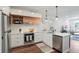 Well-lit modern kitchen featuring stainless steel appliances, quartz countertops, and sleek cabinetry with hardwood floors at 2120 N Downing St # 209, Denver, CO 80205