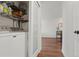 Laundry area with modern appliances, shelving for storage, and seamlessly connected to the main living space at 2120 N Downing St # 209, Denver, CO 80205