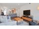 Bright living room featuring modern decor, wood floors, and an open-concept layout flowing into a stylish kitchen at 2120 N Downing St # 209, Denver, CO 80205
