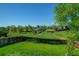 Expansive backyard with lush green grass, mature trees and a wooden fence offering privacy at 11182 W 103Rd Cir, Broomfield, CO 80021