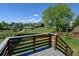 Backyard with view from the deck, mature trees, green grass and a wooden fence for privacy at 11182 W 103Rd Cir, Broomfield, CO 80021
