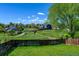 The backyard has a large grass area, mature trees, and fencing, creating a private outdoor space at 11182 W 103Rd Cir, Broomfield, CO 80021