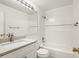 Clean, all-white bathroom features a shower over the tub and a stylish vanity sink with ample lighting at 11182 W 103Rd Cir, Broomfield, CO 80021