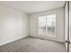 This bedroom features neutral carpet and trim and a large window that brings in natural light at 11182 W 103Rd Cir, Broomfield, CO 80021