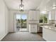 Contemporary kitchen featuring white cabinets, stainless steel appliances, with a sliding door to a deck at 11182 W 103Rd Cir, Broomfield, CO 80021
