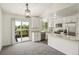 Modern kitchen with white cabinetry, stainless steel appliances, and sliding door to a deck at 11182 W 103Rd Cir, Broomfield, CO 80021