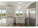 Bright, updated kitchen with stainless steel appliances and a picturesque view from the window at 11182 W 103Rd Cir, Broomfield, CO 80021
