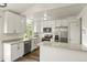 Modern kitchen with white cabinets, stainless steel appliances, and quartz countertops at 11182 W 103Rd Cir, Broomfield, CO 80021