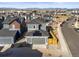 Aerial view of a home with solar panels on the roof, a two-car garage, and a fenced yard at 2754 W 69Th Ave, Denver, CO 80221