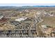 Wide aerial view of the neighborhood with new construction homes, roads and lake in the background at 2754 W 69Th Ave, Denver, CO 80221