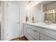 Well-lit bathroom features double sinks, white cabinetry, a large mirror, and a separate shower with glass doors at 2754 W 69Th Ave, Denver, CO 80221