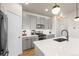 Modern kitchen features sleek gray cabinets, stainless steel appliances, a white subway tile backsplash, and pendant lighting at 2754 W 69Th Ave, Denver, CO 80221