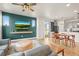 Cozy living space showcasing modern entertainment, hardwood flooring, and a seamless flow into the kitchen at 2754 W 69Th Ave, Denver, CO 80221