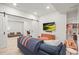 A basement living room is bright and spacious with white walls and barn door entry at 2754 W 69Th Ave, Denver, CO 80221