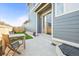 A concrete patio features wood outdoor furniture, artificial turf, and a privacy fence at 2754 W 69Th Ave, Denver, CO 80221