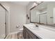 Modern bathroom featuring a single vanity and shower with glass doors at 4689 Coltin Trl, Castle Rock, CO 80104