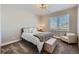 Relaxing bedroom with a neutral palette, window, and cozy armchair for reading at 4689 Coltin Trl, Castle Rock, CO 80104