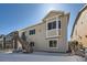 Side exterior elevation of a two-story home with neutral siding and snow covered ground at 4689 Coltin Trl, Castle Rock, CO 80104