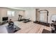 Home gym with modern exercise equipment, including a treadmill, rowing machine, and weights at 4689 Coltin Trl, Castle Rock, CO 80104