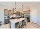 Well-appointed kitchen featuring pendant lighting, island with bar stools, and stainless steel appliances at 4689 Coltin Trl, Castle Rock, CO 80104