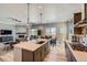 Open kitchen and living area featuring modern appliances, a dining table, and a decorative fireplace at 4689 Coltin Trl, Castle Rock, CO 80104