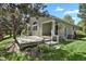 Landscaped backyard with a wooden deck with lush green lawn is perfect for entertaining at 1894 S Marshall Cir, Lakewood, CO 80232