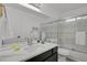Bright bathroom with white vanity, dual sinks, and shower-tub combination at 1894 S Marshall Cir, Lakewood, CO 80232