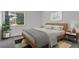 Relaxing bedroom featuring a large window and a comfortable bed with stylish decor at 1894 S Marshall Cir, Lakewood, CO 80232