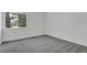 Empty bedroom with a large window and neutral paint provides a serene space at 1894 S Marshall Cir, Lakewood, CO 80232