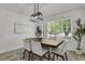 Modern dining room with stylish light fixture, seating for six, and large window at 1894 S Marshall Cir, Lakewood, CO 80232
