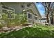 The exterior of the home shows manicured lawn and lush landscaping at 1894 S Marshall Cir, Lakewood, CO 80232
