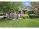 Charming home featuring a lush green lawn and mature shade tree with manicured landscaping at 1894 S Marshall Cir, Lakewood, CO 80232