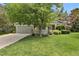 Charming home featuring a lush green lawn and mature shade tree in a desirable neighborhood at 1894 S Marshall Cir, Lakewood, CO 80232